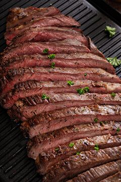 Seared flank steak on a grill pan with chimichurri and horseradish