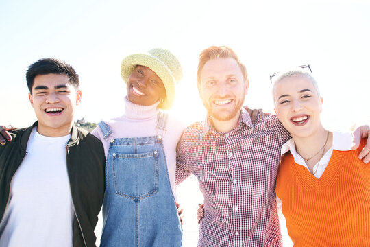 Happy portrait of Smiling group of multicultural friends looking at the camera. Cheerful multi-ethnic happy young people of diverse races having fun together. Community and friendship