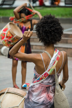 Woman playing Maracatu drums, a musical rhythm of cultural feasts typical of northeastern Brazil.