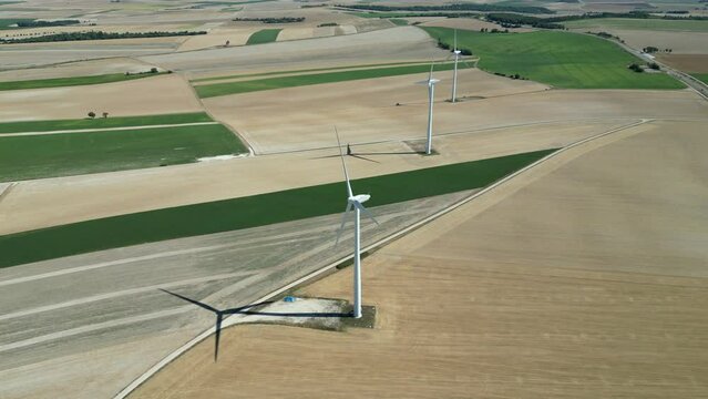 View from a drone of a wind farm in the countryside of France in the middle of the fields

