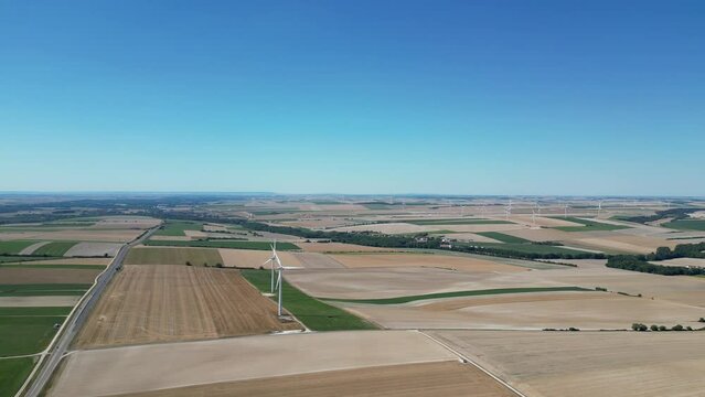 View from a drone of a wind farm in the countryside of France in the middle of the fields
