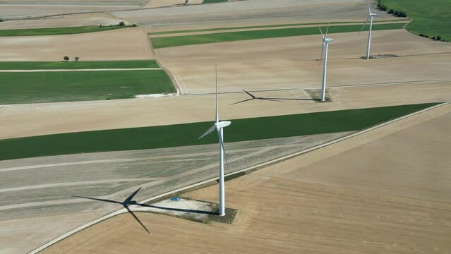View from a drone of a wind farm in the countryside of France in the middle of the fields