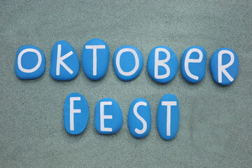 Oktoberfest, the world`s largest Volksfest, featuring a beer festival and a travelling funfair. It is held annually in Munich, Bavaria, Germany. Creative text composed with blue colored stone letters 