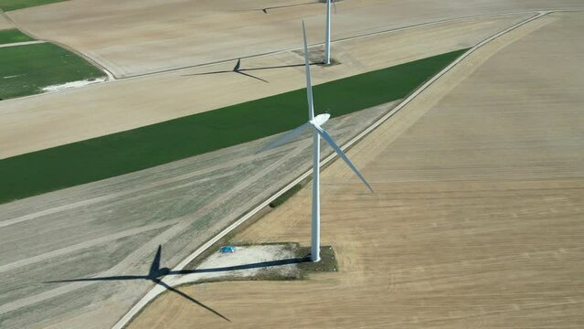 View from a drone of a wind farm in the countryside of France in the middle of the fields