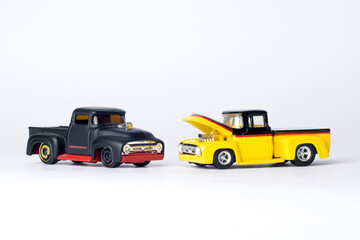 two trucks toy black and yellow with white background