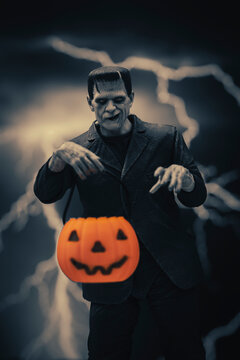 NEW YORK USA, SEPT 5 2022: Frankenstein monster looming with trick or treat jack o lantern pail - Neca action figure 