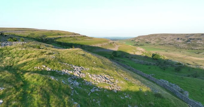 Aerial shot of Chapel le dale in early morning sunlight
