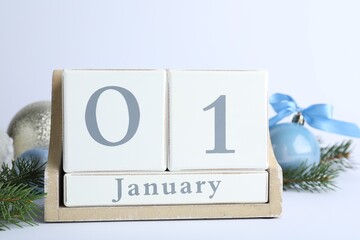 Block calendar and Christmas decor on white background. New Year celebration
