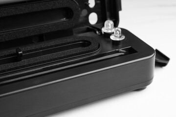 Sealer for vacuum packing on white table, closeup