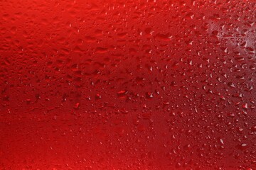 Glass of tasty cold beer with condensation drops as background, closeup