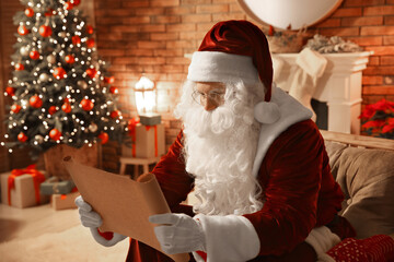 Santa Claus in glasses reading wish list indoors