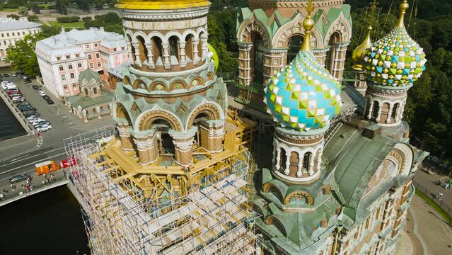 Aerial around view of a domes of the Savior on Spilled Blood next to park in the historical and at same time modern city of St. Petersburg at sunny summer afternoon, close to roof
