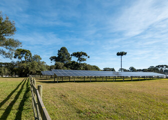 Solar panel installed in a farm, green background - concept of sustainable resources, photovoltaic, alternative electricity source