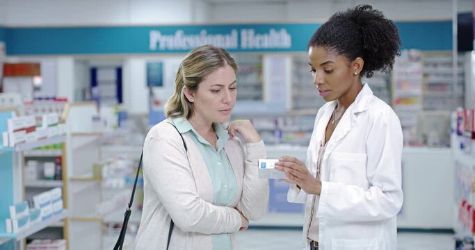 Doctor or pharmacist consulting customer or patient with medicine and professional advice at a pharmacy. Medical expert with great customer service, pills and health care treatment to woman in store