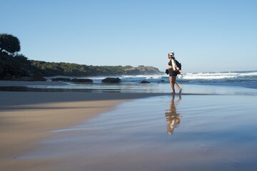 Women travel the world on beautiful beach with reflection in australia with blue skies
