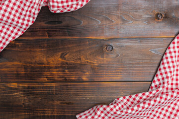 Checkered red and white on an old wooden background with copy space, flat lay, top view. Top view textile a checkered red and white on the table wood. - Powered by Adobe