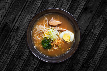 SHOYU RAMEN, Chicken, chicken and pork concentrate accompanied with noodles, pieces of pork, egg and vegetables.
