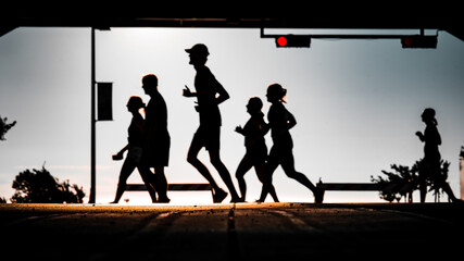 silhouettes of people running