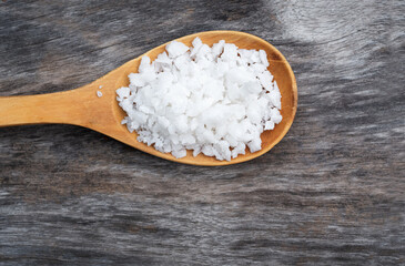 Sea salt in a spoon on a wooden
