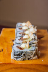 TNT MAKI, Stuffed with shrimp, avocado with a sheet of fan shells.