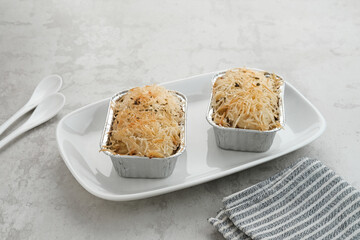 Baked Macaroni Schotel in an aluminium foil cup.