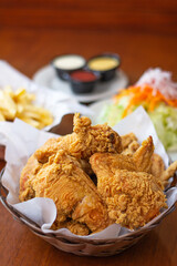 Broaster chicken, served with potatoes and salad
