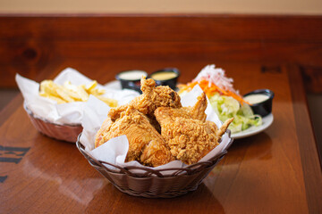 Broaster chicken, served with potatoes and salad
