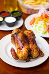 Grilled chicken, on plate, traditional Peruvian food
