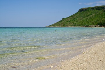 Scenery of the calm sea and peninsula of the Aragusuku Beach