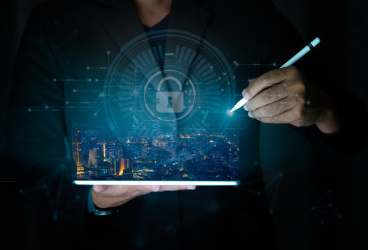 Computer security concept. Businessman holding tablet with cityscape. Symbol of safe.Hackers attack internet security.key and shield icon Refers to the organization's information security system.