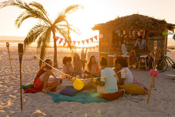 Mixed race friends group having fun on beach