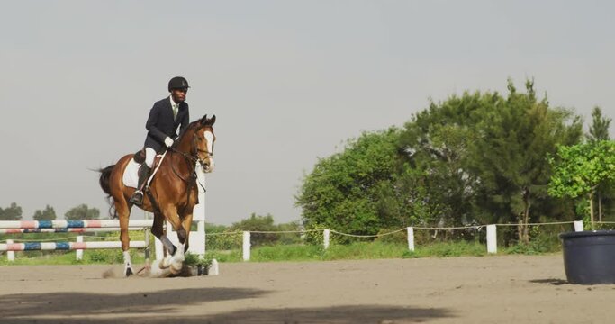 African American man jumping an obstacle with his Dressage horse