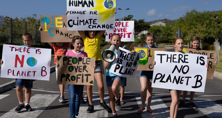Group of elementary school pupils walking on a protest march
