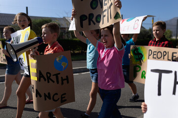 Group of elementary school pupils walking on a protest march