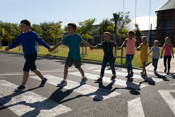Group of elementary school pupils crossing a road