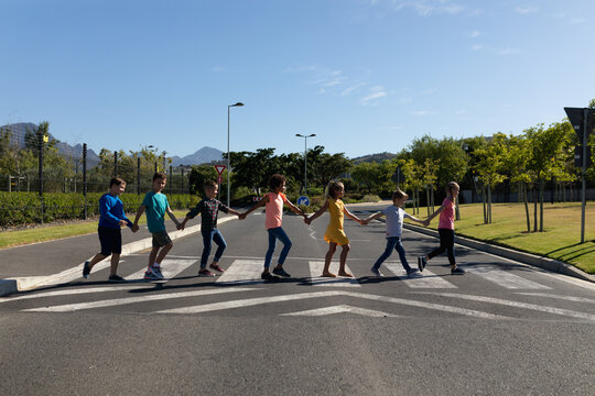 Group of elementary school pupils crossing a road