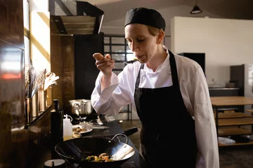 Fotobehang Caucasian chef tasting the vegetables © wavebreak3