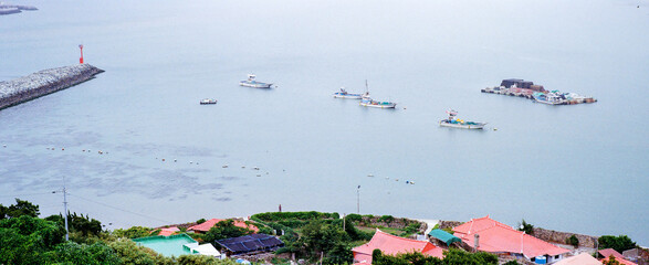 Sea village and fishing boats moored on the blue sea