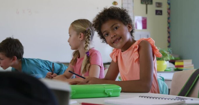 Girl smiling while studying in the class