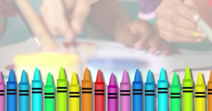Multiple colored crayons against mid section of kids painting