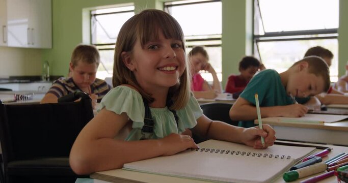 Physically challenged girl smiling in the class