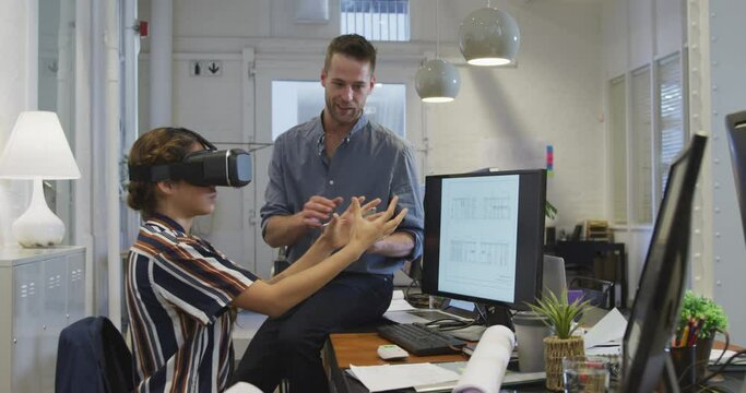 Businesswoman wearing VR helmet in modern office