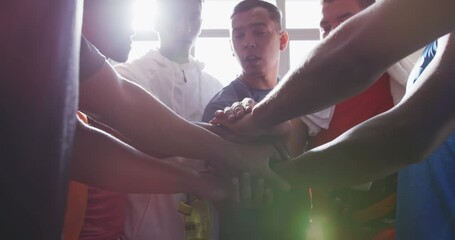 Coach and soccer players motivating in the locker room - Powered by Adobe