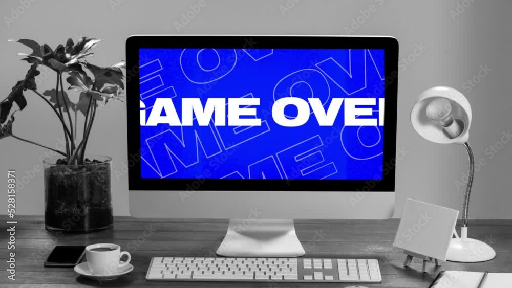 Poster animation of multiple game over white text over computer screen on desk on grey background