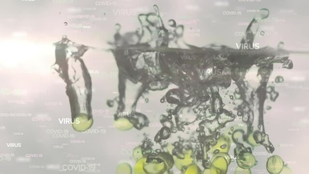 Animation of floating Covid-19 words over pills falling into water 