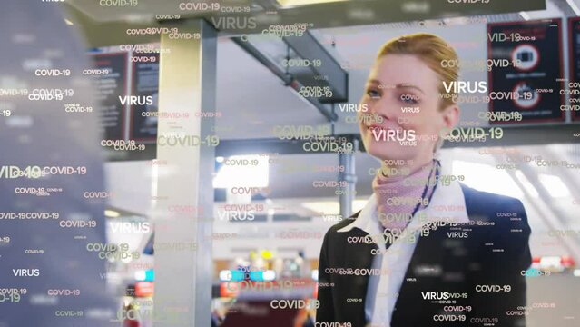 Animation of floating Covid-19 words over Caucasian airport worker during passport control