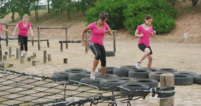 Female friends enjoying exercising at boot camp together