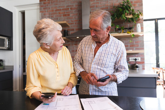  Senior Caucasian couple doing administrative work