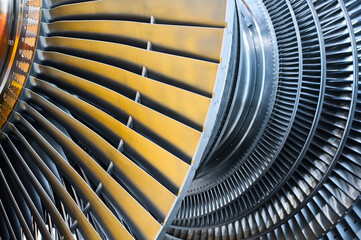 Shiny rotor of powerful steam turbine in light workshop