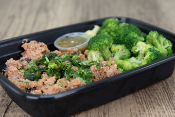 Take out order of ground turkey with rice and broccoli is conveniently packed in a microwavable container.